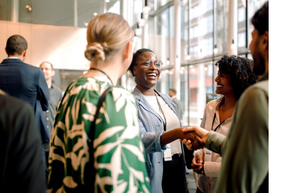 People shaking hands and making introductions at a networking event.