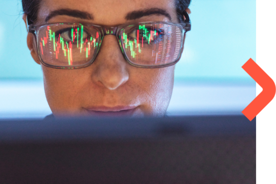 Close up of woman in glasses looking at a laptop screen.